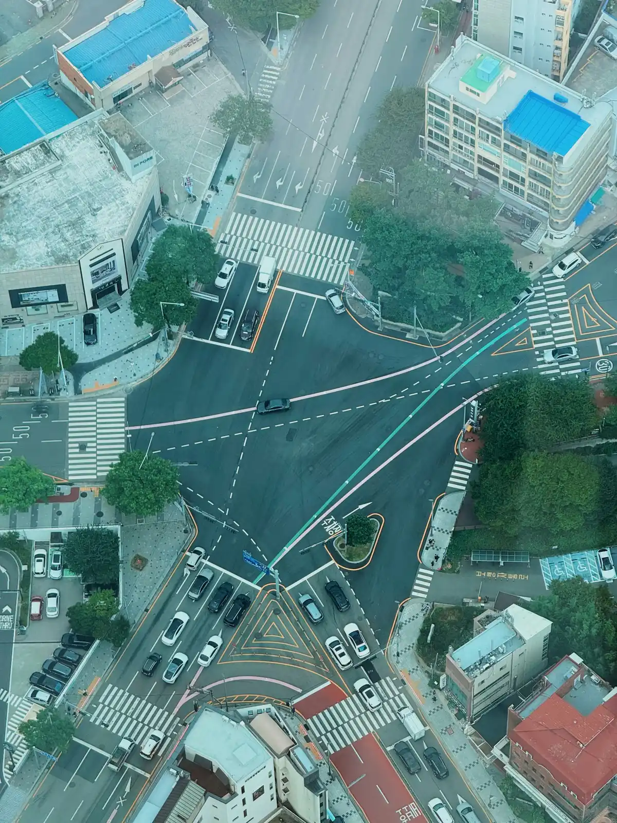 An aerial view of a busy city intersection, representing modern mobility and operational complexity.