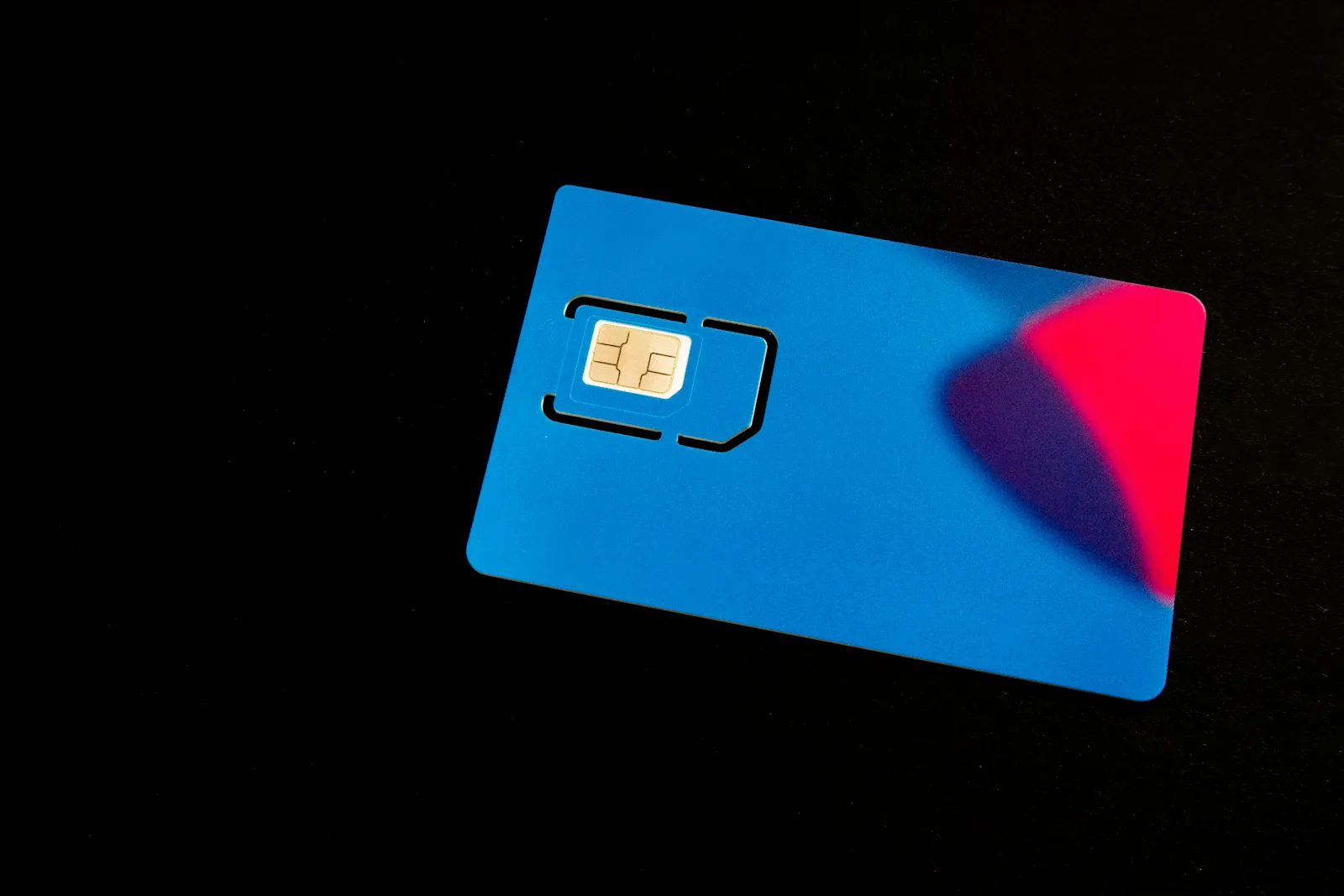 A close-up of a SIM card on a surface, representing connectivity decisions for mobility and IoT.